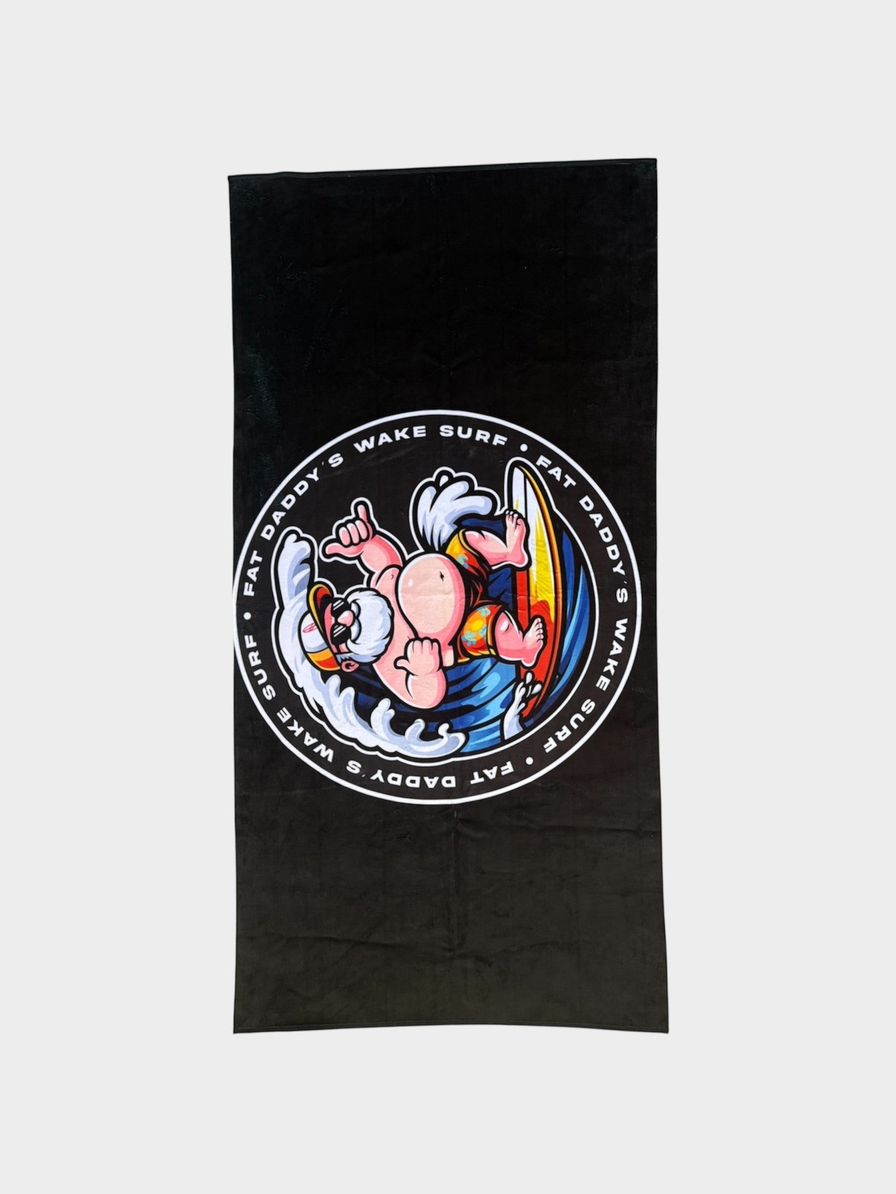 Fat Daddy's Wake Surf black quick-dry towel featuring a cartoon character surfing on a surfboard with waves.