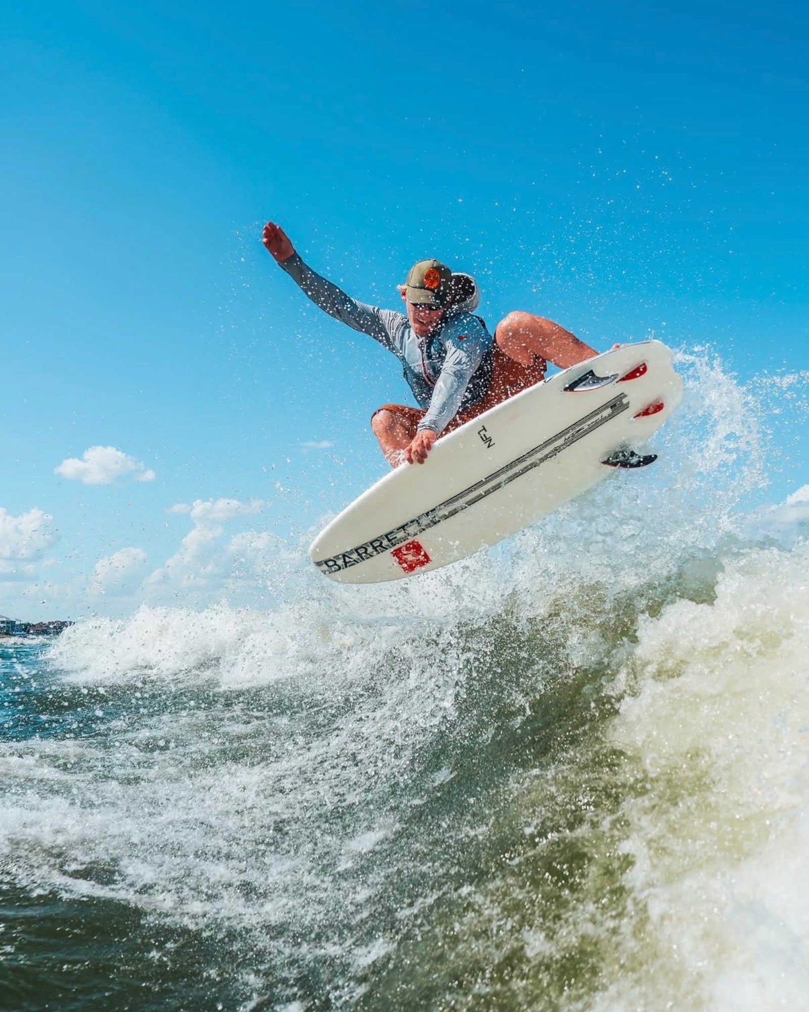 Fat Daddy's Wake Surf Noah Flegel Pro NF1 wakesurf board being ridden in a high jump over a wave on a sunny day