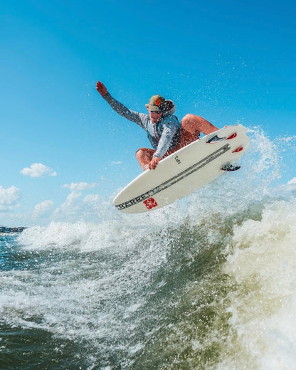 Fat Daddy's Wake Surf Noah Flegel Pro NF1 wakesurf board being ridden in a high jump over a wave on a sunny day